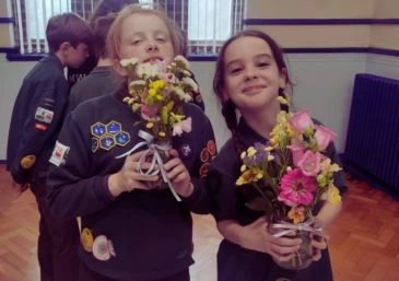 Cubs flower arranging into jam jars. The class was donated and taught by Gemma from Booker Flowers and Gifts